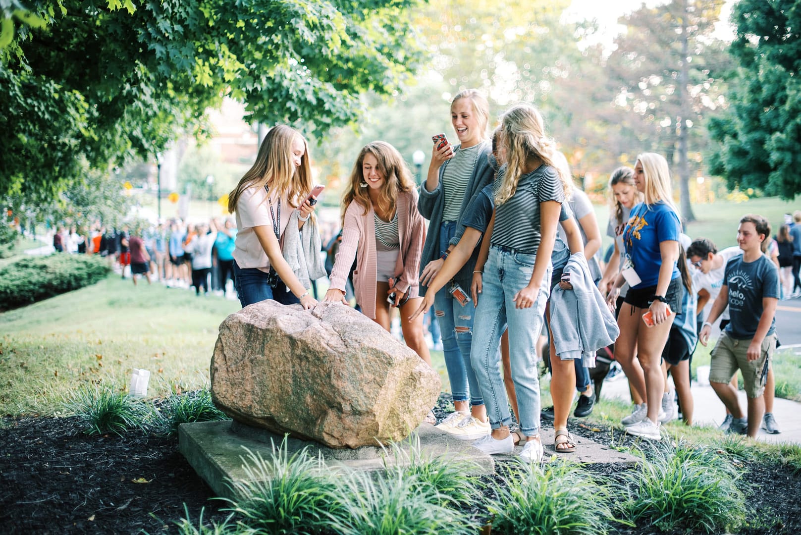 Walk to the Rock Students touching Pioneer Rock