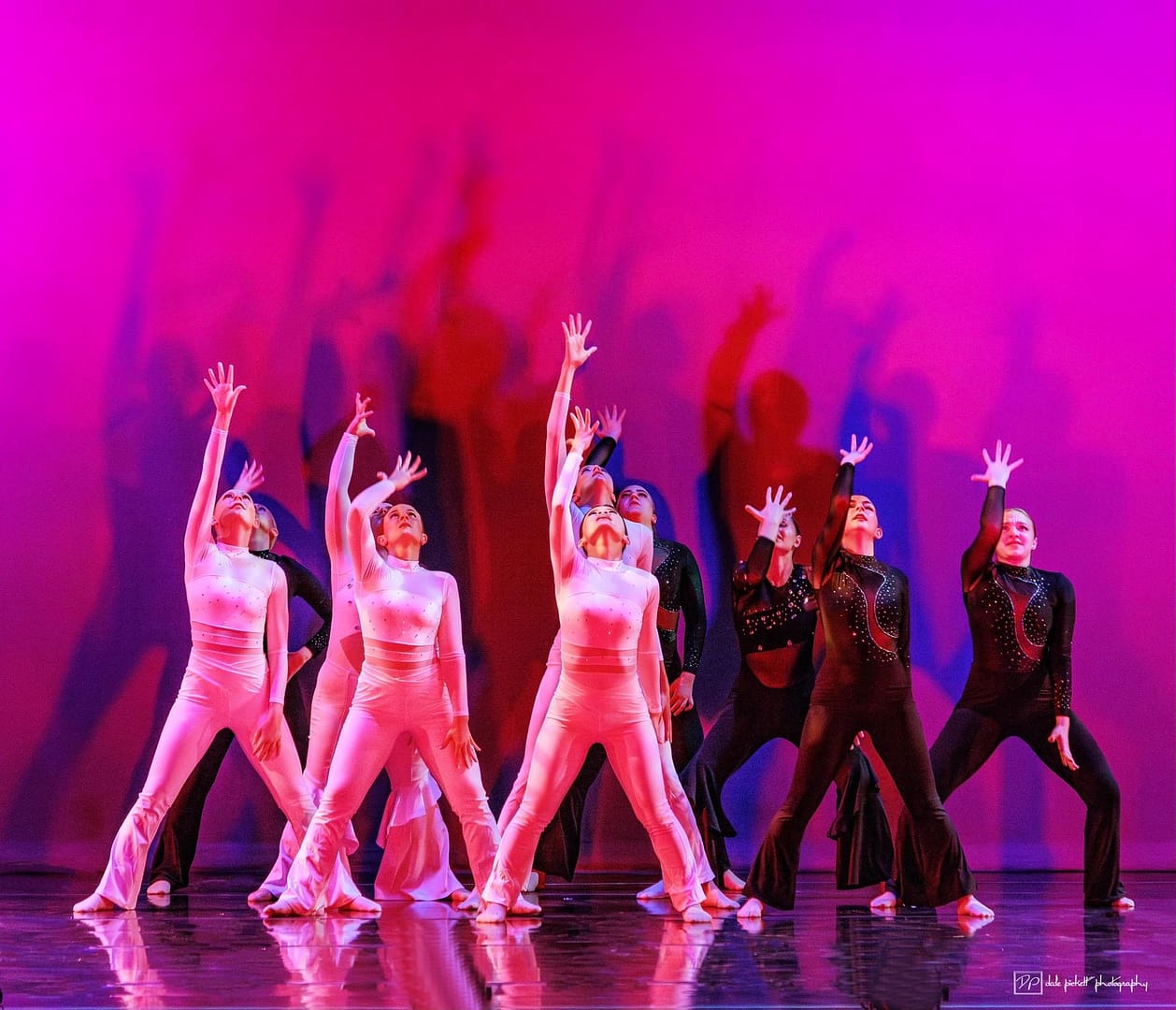 A group of students perform a routine on stage