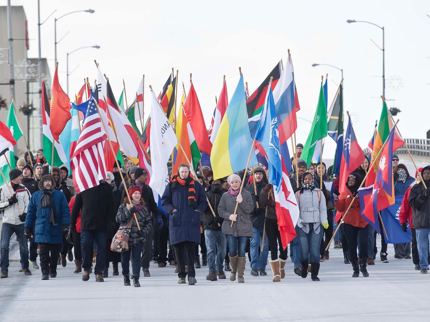 Anderson University community marching through Anderson with flags