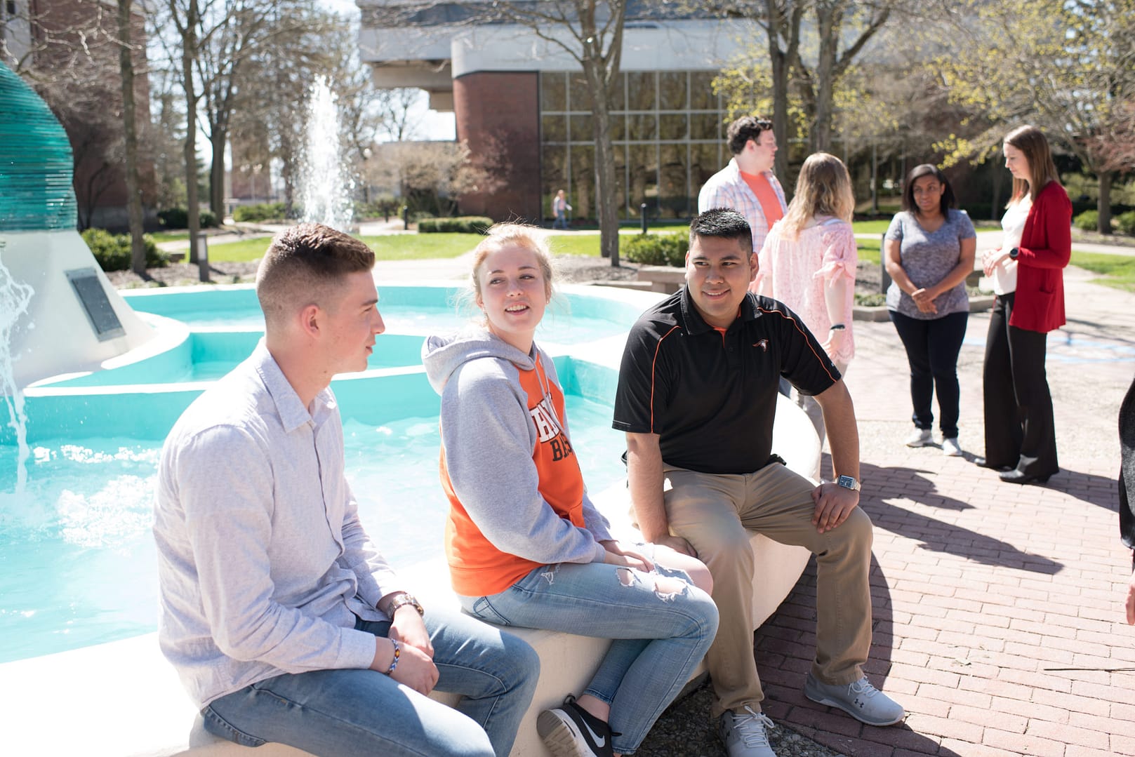 Students sitting at Helios monument.