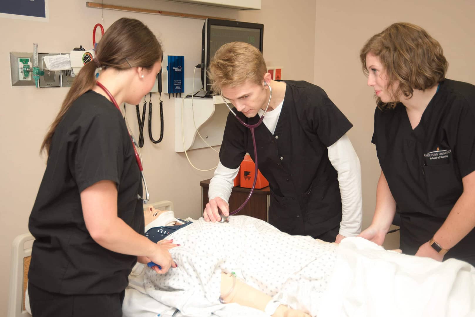 three nursing students in a lab