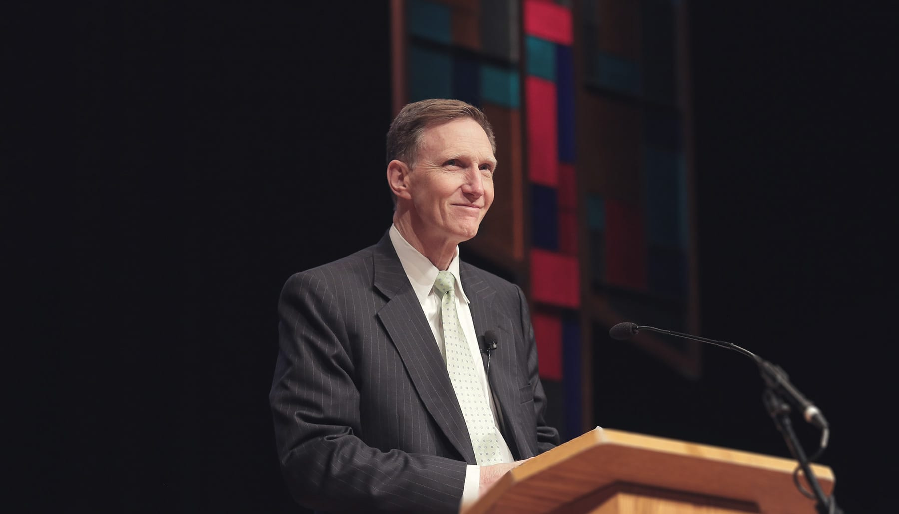 President Pistole at a podium addressing students at chapel.