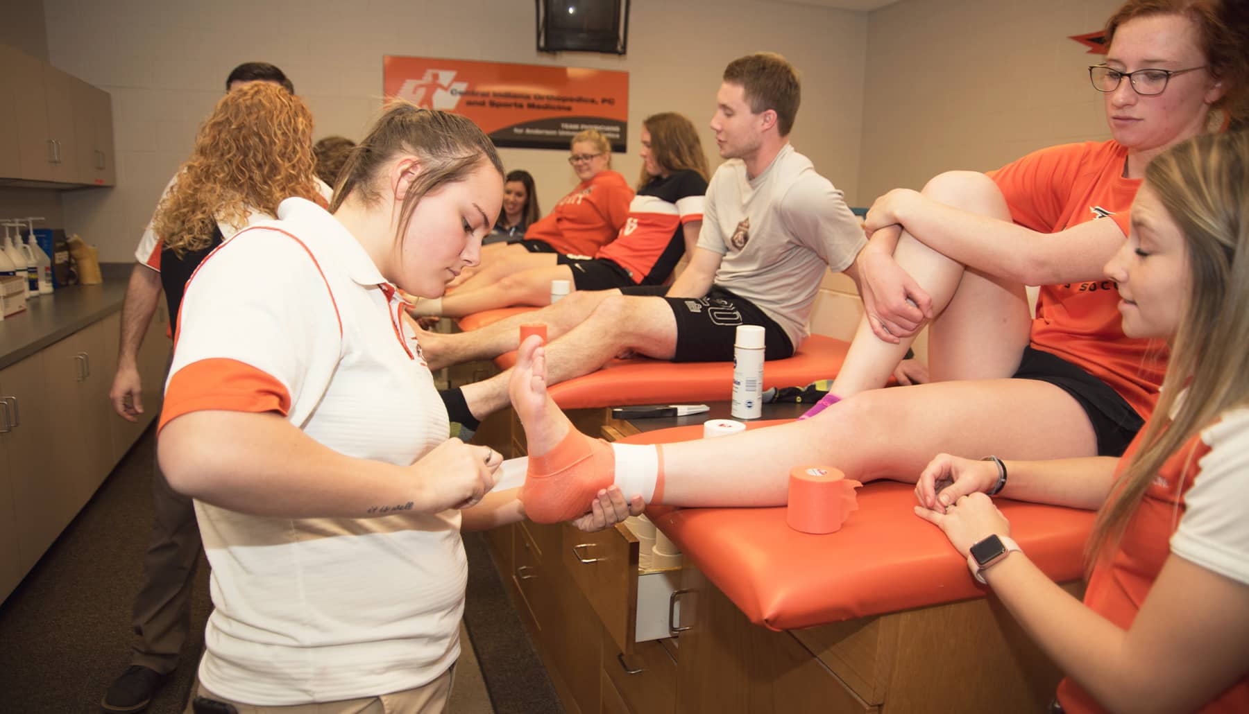 athletic training students practice taping feet and ankles