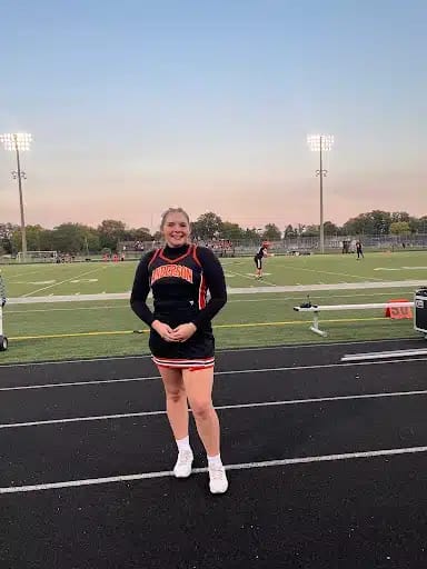 Isabelle Donihue poses in her cheerleading outfit. 